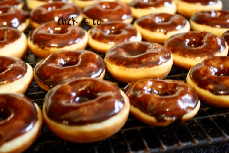 a batch of mini chocolate coated doughnuts